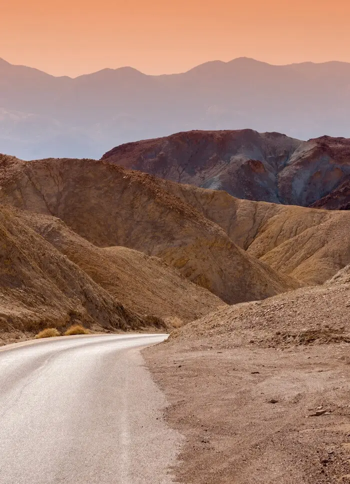 Desert road winding through mountains