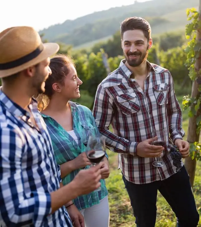 People enjoying wine vineyard tour