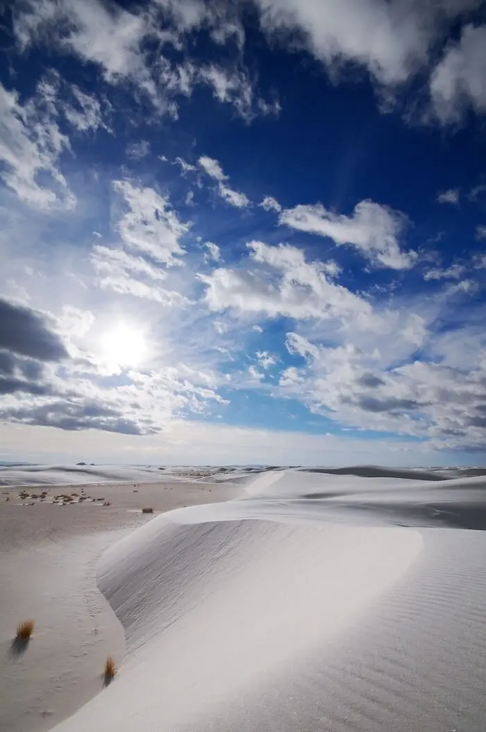 White sand dunes under sky