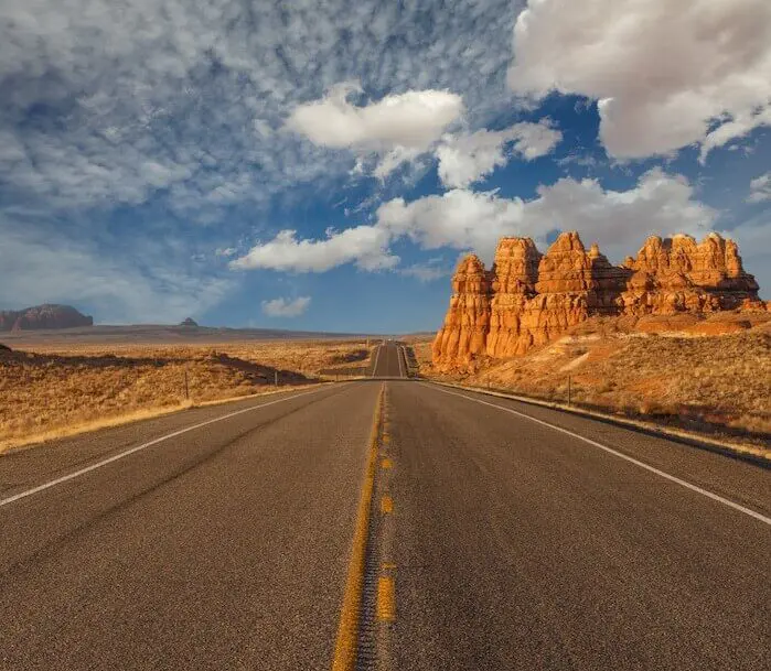 Desert highway under cloudy sky