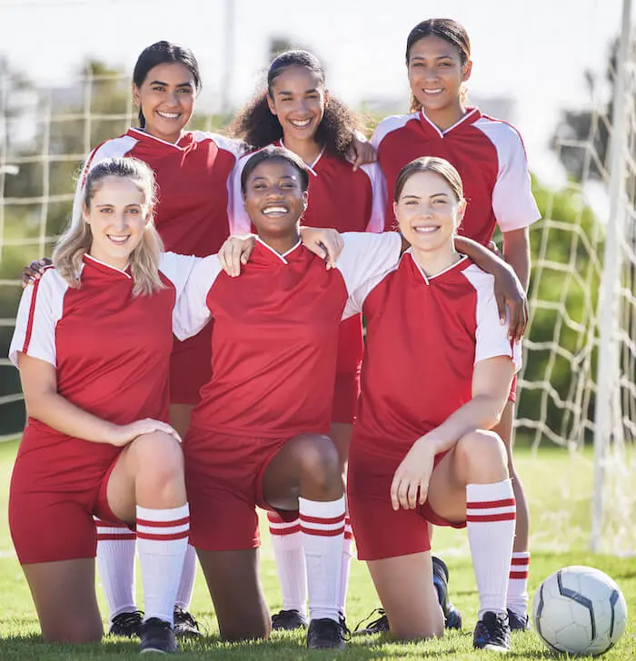 Womens soccer team posing outdoors