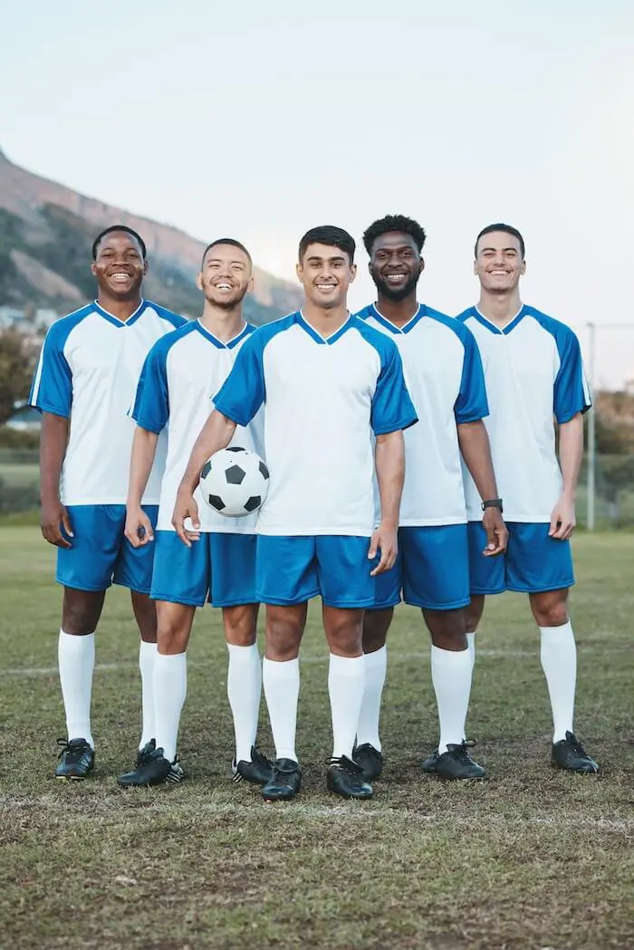 Soccer team smiling on field