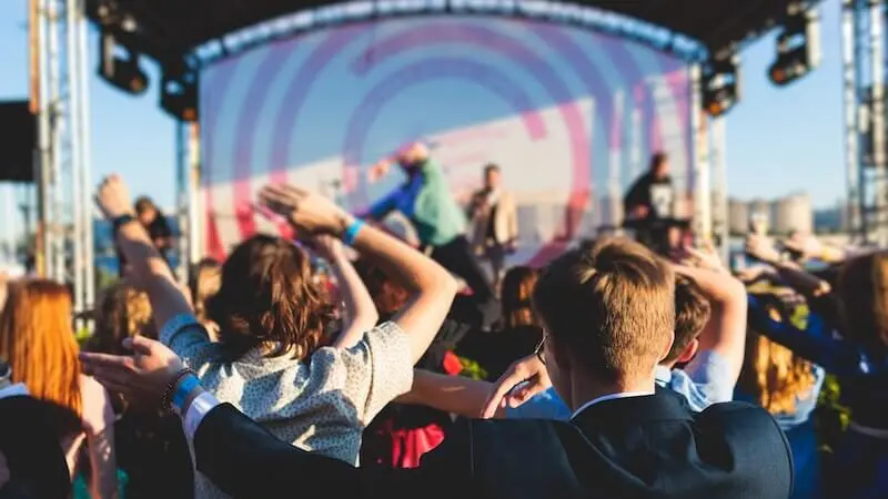 Outdoor music festival crowd dancing