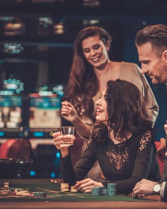 People enjoying casino gaming table