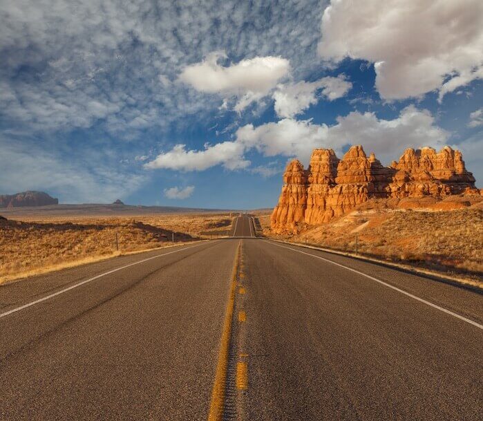 Desert highway under cloudy sky